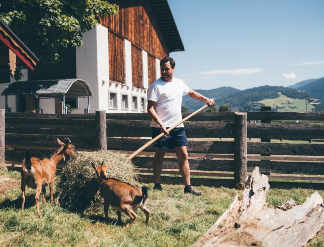 Bauer beim Tiere füttern © Lorenz Masser Fotografie