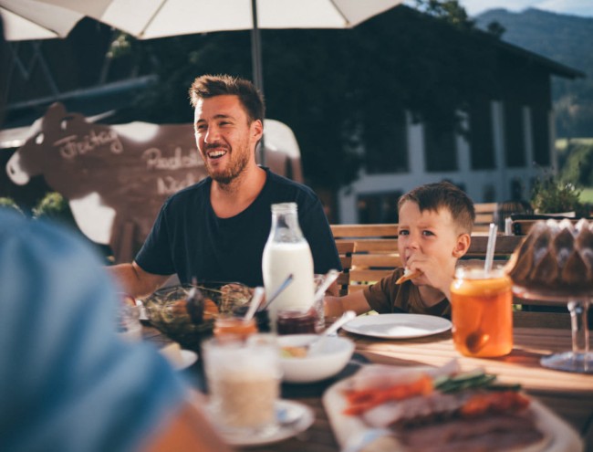 Glückliche Gäste genießen ein Abendessen im Freien im Obersulzberggut in Radstadt © Lorenz Masser Fotografie