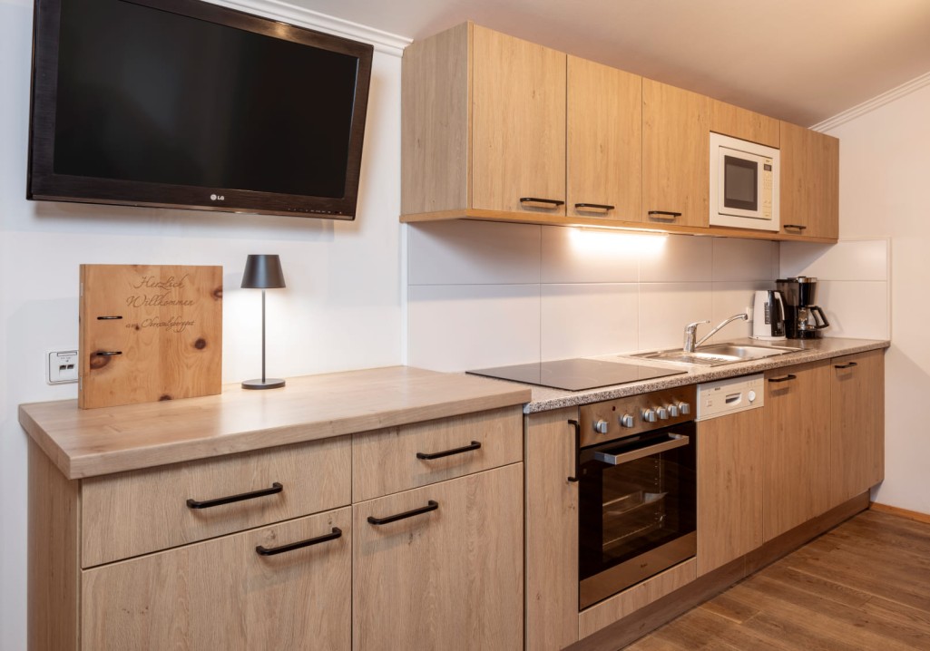 Modern kitchen with wooden cabinets and appliances at Obersulzberggut in Salzburg © Lorenz Masser Photography